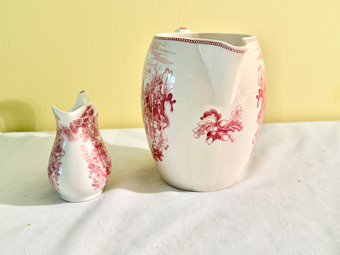 Pair of Red and White Pitchers