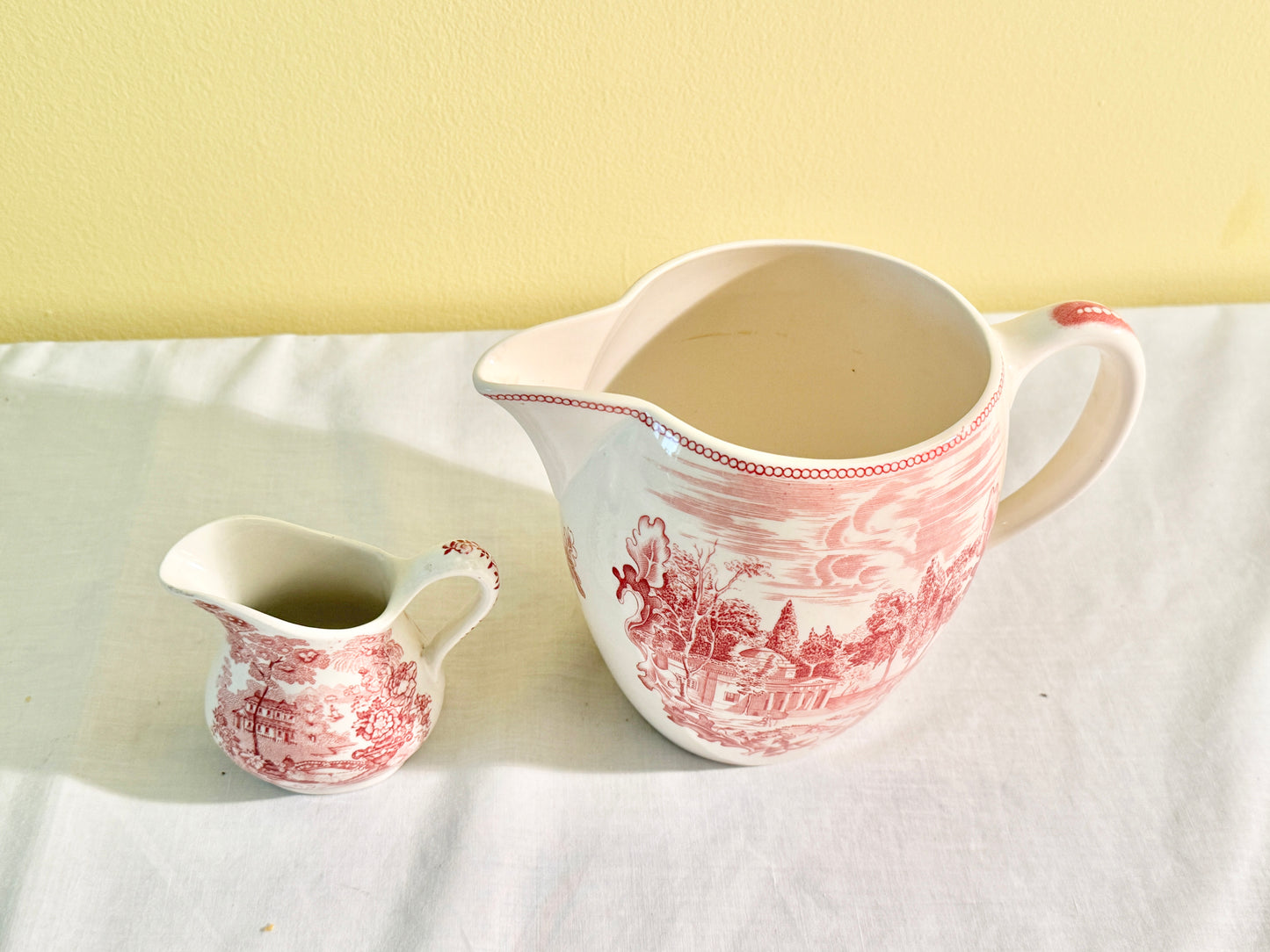 Pair of Red and White Pitchers