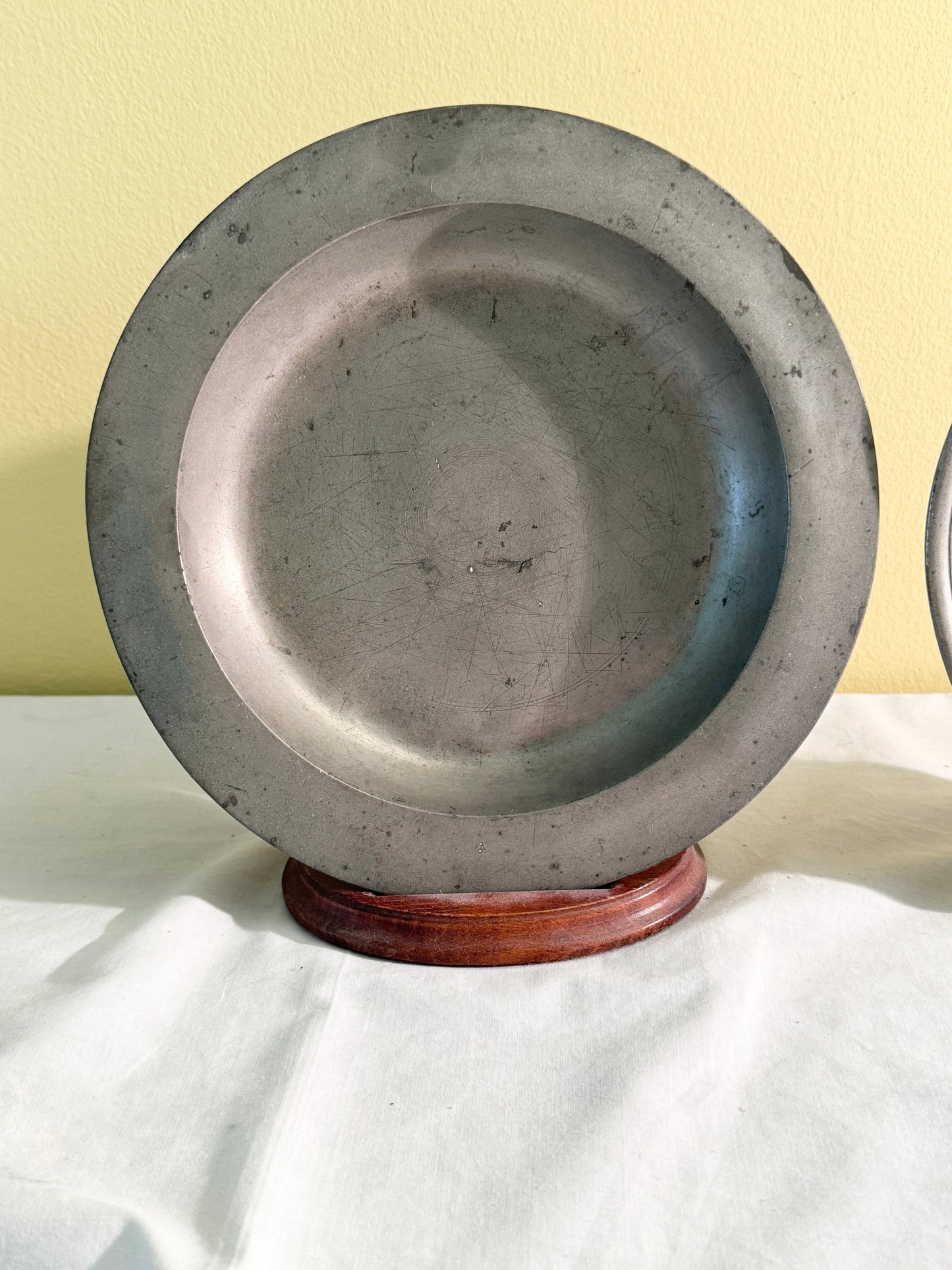 Pair of pewter plates with stands